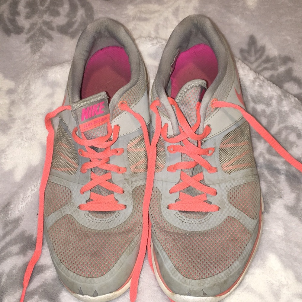 grey and orange NIKE shoes